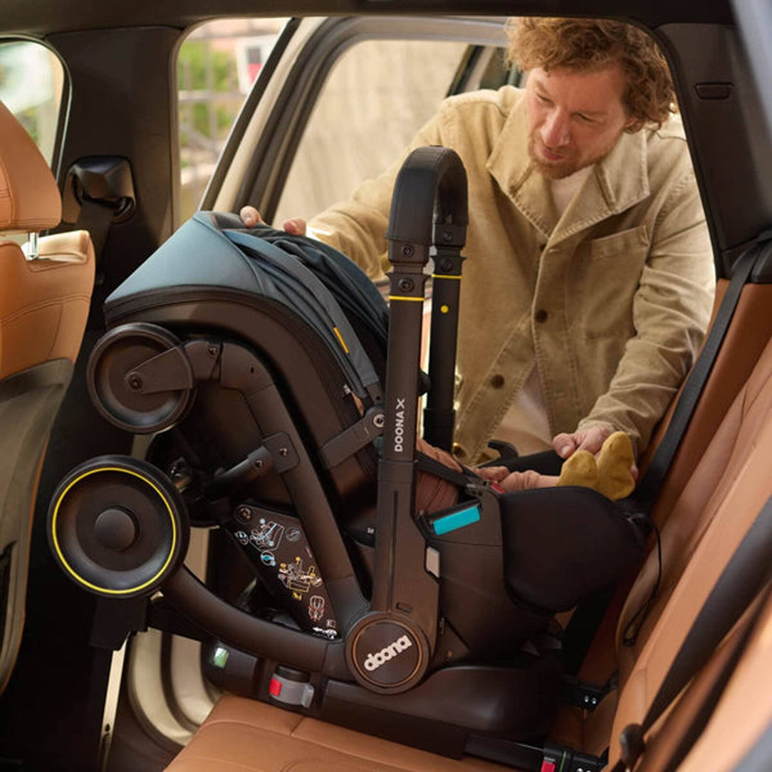 DOONA X Infant Car Seat - Nitro Black & Free Essentials Bag - Gold