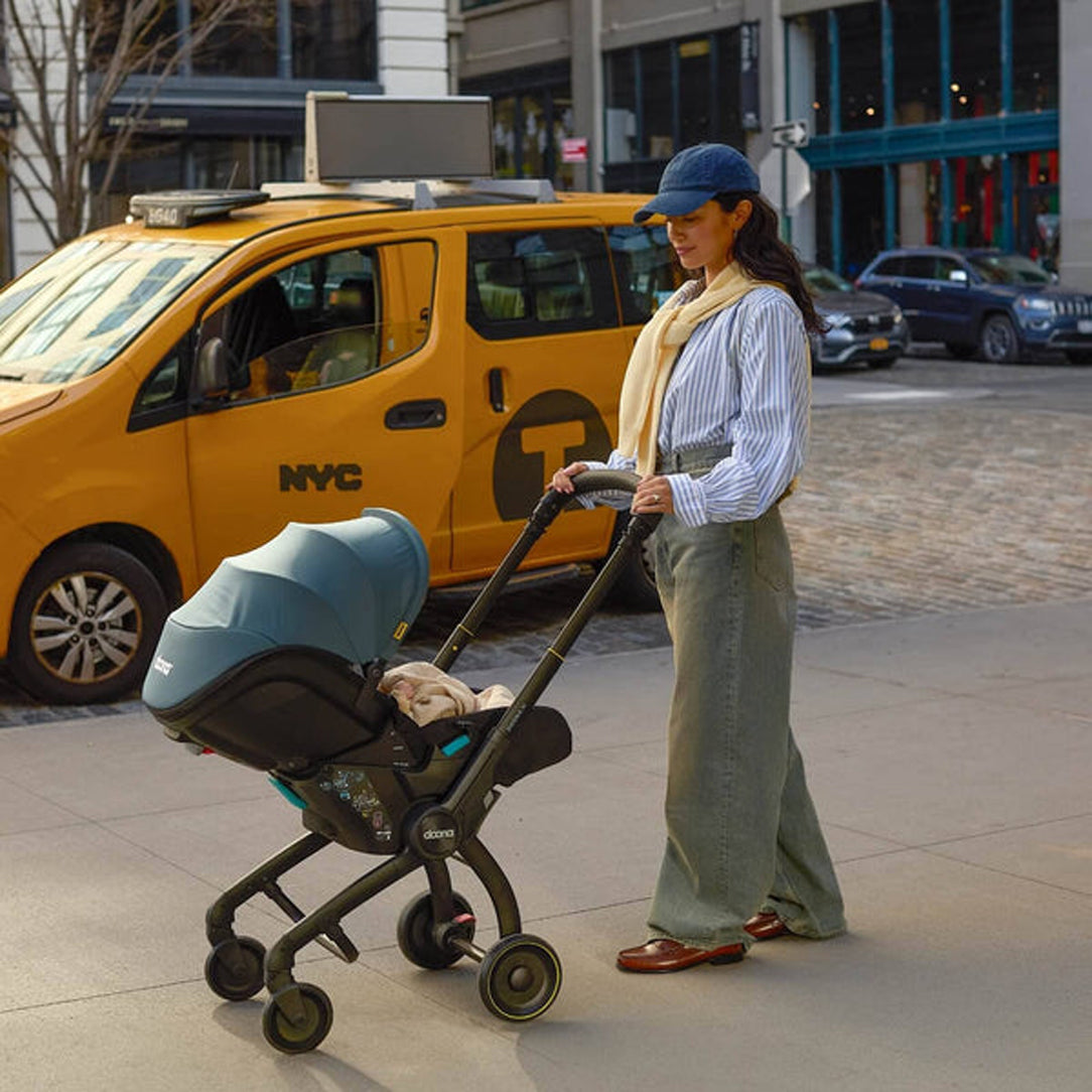 DOONA X Infant Car Seat - Dusty Sage & Free Essentials Bag - Gold