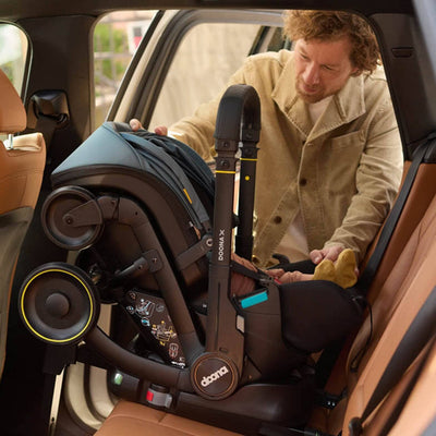 DOONA X Infant Car Seat - Dusty Sage & Free Essentials Bag - Gold